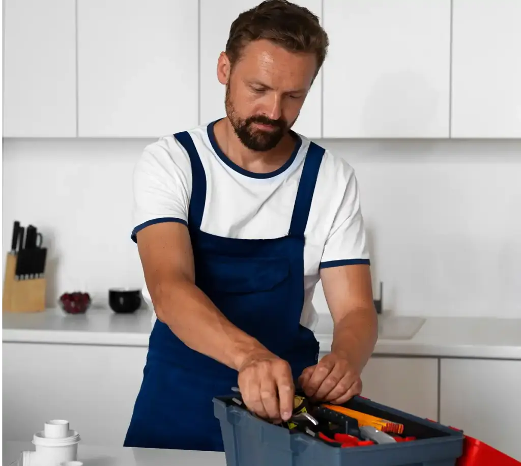 Technicus organiseert reparatietools in een gereedschapskist terwijl hij zich voorbereidt op huishoudelijk onderhoud